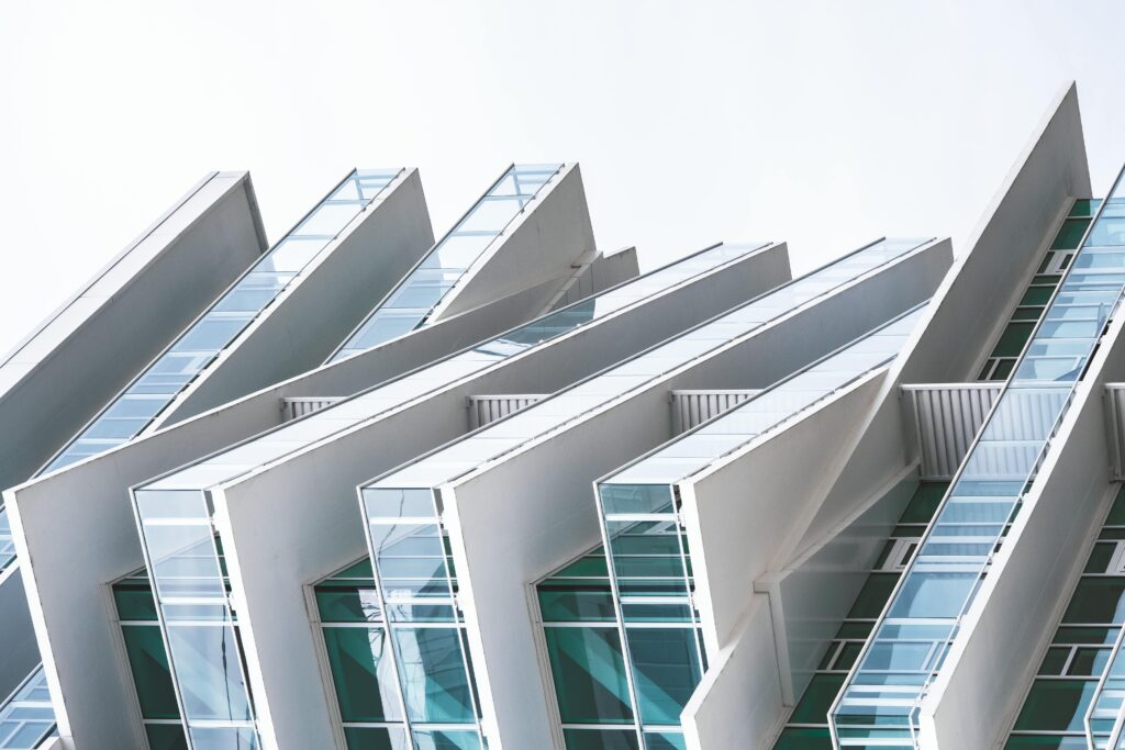 Contemporary building facade with unique geometric design and glass elements.