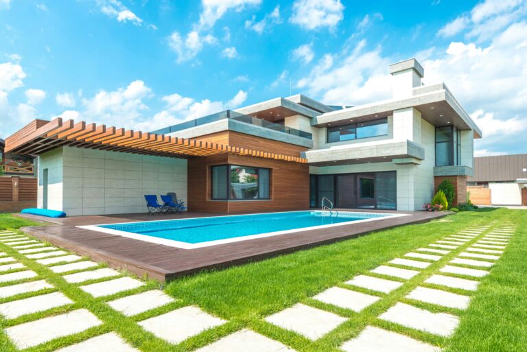 Home Contemporary house with pool, lush lawn, and clear skies.