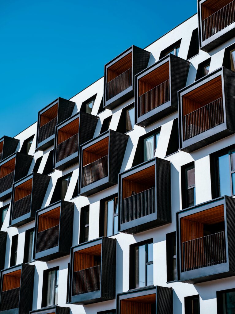 Contemporary architectural facade of a building in Poznań, Poland with unique balconies.